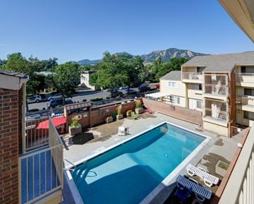 Boulder apartment for rent - A pool in a courtyard surrounded by buildings.