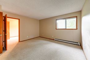 Boulder townhouse for rent - A room with a carpeted floor, a window, and a door.