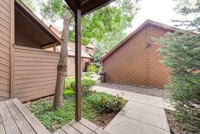 Boulder townhouse for rent - A brown wooden building with a tree in front of it.
