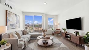 Denver apartment for rent - A modern living room with a large window and a flat screen TV.