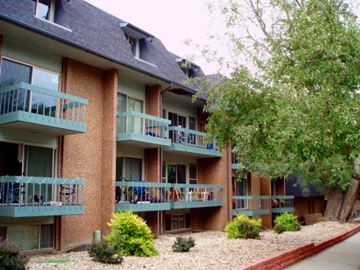 Boulder apartment for rent - an apartment building with balconies and trees