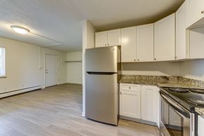 Boulder apartment for rent - A kitchen with a stainless steel refrigerator and white cabinets.