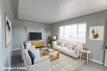Edgewater apartment for rent - A living room with a white couch and a wooden coffee table.