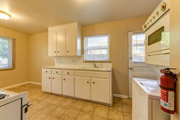 Denver apartment for rent - a kitchen with a stove sink and a microwave
