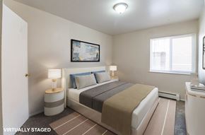 Denver apartment for rent - A bedroom with a bed, nightstands, and a painting on the wall.