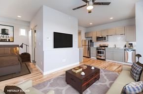 Lakewood apartment for rent - A modern living room with a flat screen TV mounted on the wall.