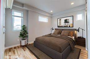 Lakewood apartment for rent - A bedroom with a large bed and a painting on the wall.
