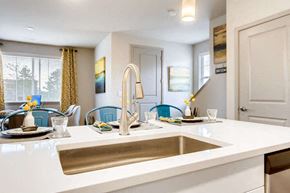 Aurora townhouse for rent - Kitchen with a white countertop and a stainless steel sink at The Point at Biscay, Aurora