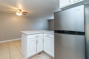 Englewood apartment for rent - A kitchen with a white cabinet and a stainless steel refrigerator.