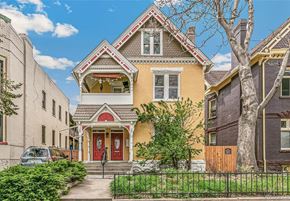 Denver apartment for rent - A yellow house with a red door is in front of a grey house.