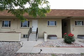 Denver apartment for rent - A house with a red roof and a white door.