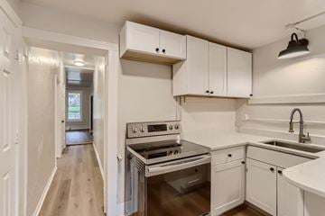 Boulder apartment for rent - A kitchen with white cabinets and a stainless steel oven.