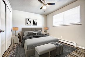 Arvada apartment for rent - a bedroom with a bed and a ceiling fan