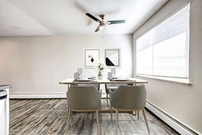 Arvada apartment for rent - a dining room with white walls and a ceiling fan