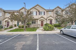 Thornton apartment for rent - A silver car is parked in a parking lot in front of a two-story house.