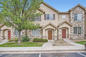 Thornton apartment for rent - A two-story house with a red door and a tree in front.