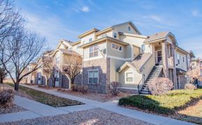 Denver townhouse for rent - A row of houses with a sidewalk in front.