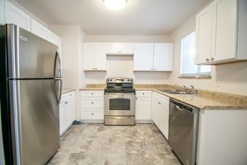 Edgewater apartment for rent - a kitchen with stainless steel appliances and white cabinets