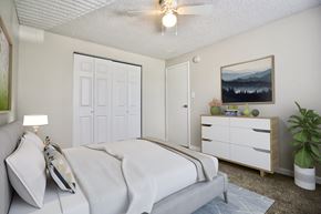 Westminster apartment for rent - A bedroom with a bed, nightstand, and a painting on the wall.