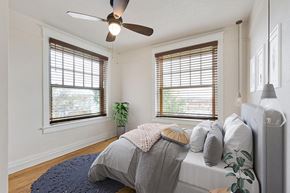 Denver apartment for rent - a bedroom with two windows and a ceiling fan