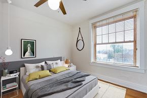 Denver apartment for rent - a bedroom with a large window and a ceiling fan
