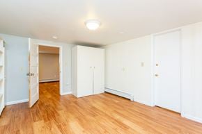 Boulder triplex for rent - a renovated living room with wood floors and white walls