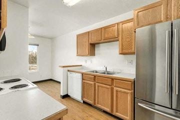 Fort Collins townhouse for rent - a kitchen with stainless steel appliances and wooden cabinets