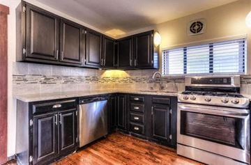 Denver apartment for rent - a kitchen with black cabinets and stainless steel appliances