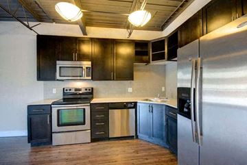 Boulder apartment for rent - a kitchen with stainless steel appliances and wooden cabinets
