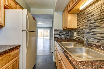 Lafayette apartment for rent - A kitchen with a white refrigerator and a granite counter top.