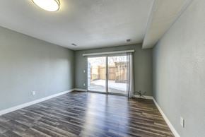 Lafayette townhouse for rent - the living room of a home with gray walls and a sliding glass door to a backyard