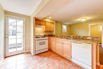 Boulder triplex for rent - a kitchen with a stove a sink and a door