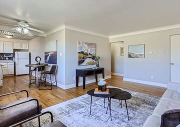 Denver apartment for rent - A living room with a black table and chairs.