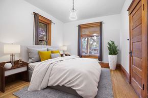Boulder apartment for rent - A bedroom with a large bed and a window with a view of trees.