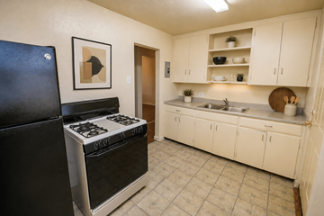 Aurora apartment for rent - A black stove in a kitchen with white cabinets.