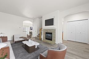 Thornton townhouse for rent - A living room with a fireplace and a television.