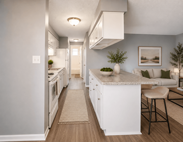 Englewood apartment for rent - A kitchen with white cabinets and a white island with a bowl on top.