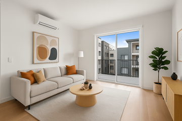Denver apartment for rent - A living room with a grey couch, a coffee table, and a painting on the wall.