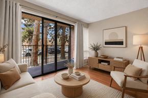 Boulder apartment for rent - A living room with a white couch, a wooden coffee table, and a lamp.