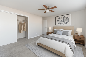 Aurora apartment for rent - A bedroom with a large bed and a ceiling fan.