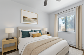 Denver apartment for rent - A bedroom with a large bed and a painting on the wall.
