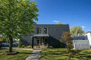 Englewood apartment for rent - A modern house with a grey exterior and a large front yard.