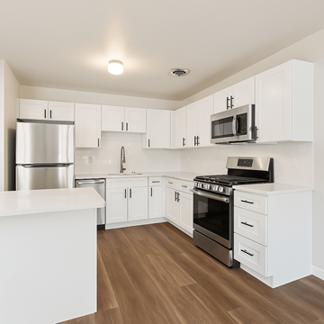 Boulder triplex for rent - A kitchen with white cabinets and appliances.