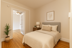 Denver apartment for rent - A bedroom with a bed, nightstand, and plant.