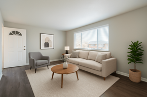 Aurora apartment for rent - A living room with a grey couch, a grey armchair, a wooden coffee table, and a potted plant.