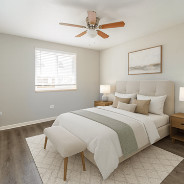 Aurora apartment for rent - A bedroom with a large bed and a ceiling fan.