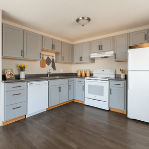 Aurora apartment for rent - A kitchen with white appliances and grey cabinets.