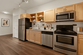 Denver apartment for rent - A kitchen with wooden cabinets and stainless steel appliances. at B Street Lohi Apartments, Denver, CO
