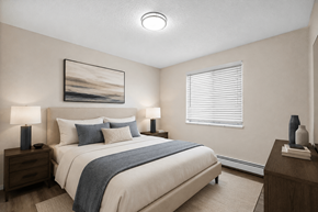 Denver apartment for rent - A bedroom with a large bed, two nightstands, and a painting on the wall.