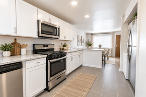Wheat Ridge apartment for rent - A kitchen with white cabinets and stainless steel appliances.